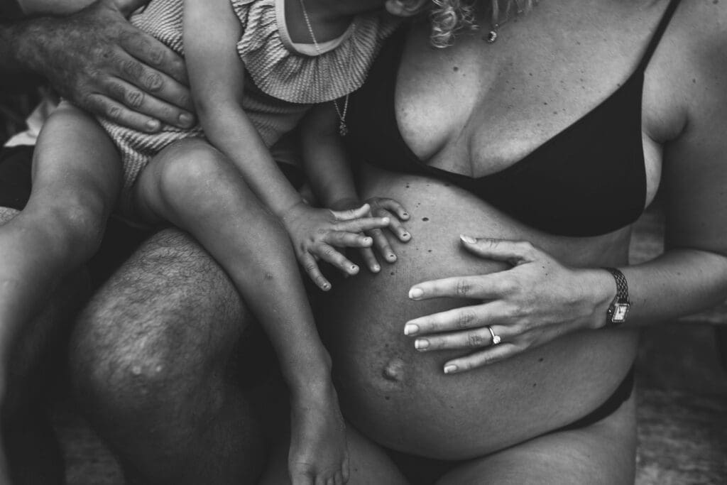 blackand white photograph of a maternity photo shoot at the beach
