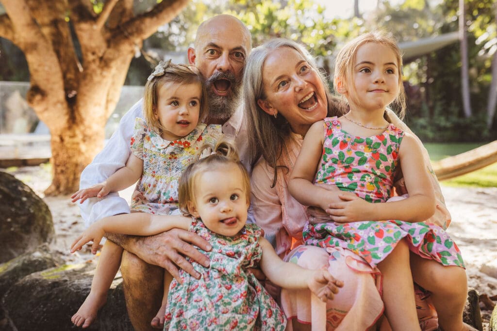 Extended family photography session on a Byron Bay beach at sunset with multiple generations together